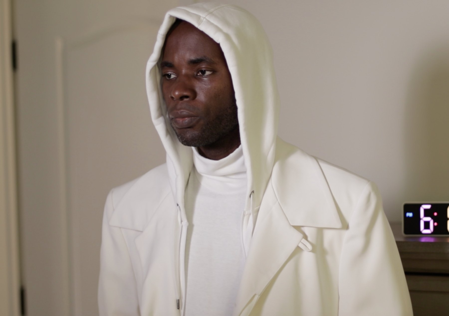 Holy One in white hooded clothing.